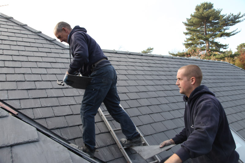 Mick and Paul Carter working on a slate roof