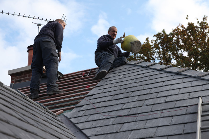 Mick and Paul Carter up on a ridge beside a chimney