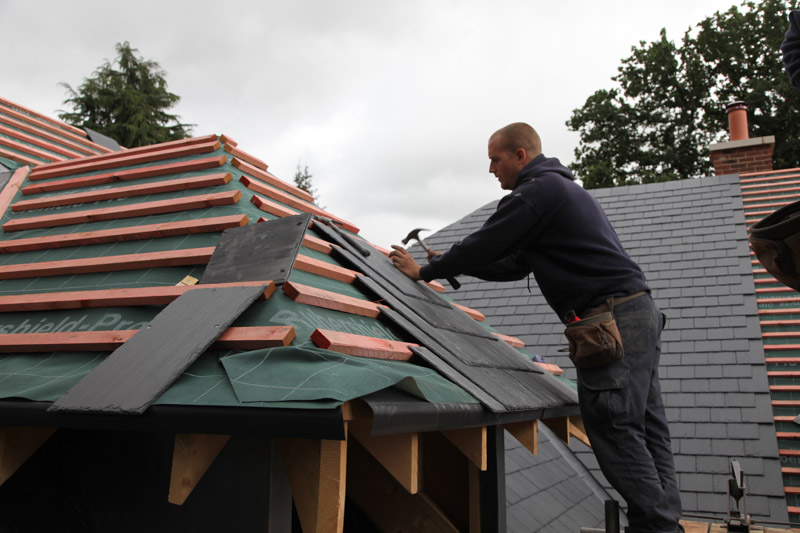 Paul Carter fixing tiles on a dormer hip